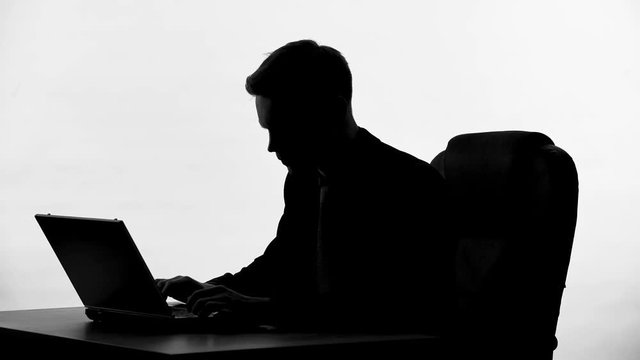 Press secretary silhouette typing government statement, man working on project