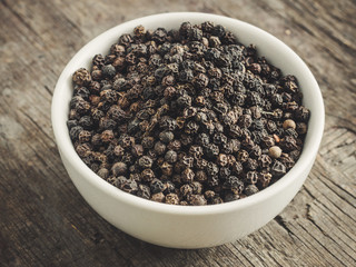 black pepper peas - spices - new crop on a wooden surface
