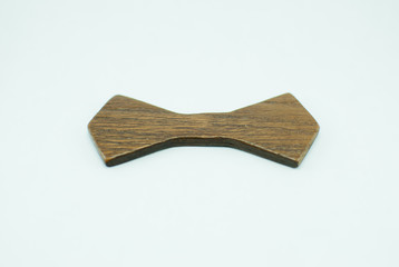 Brown wooden shape of bow tie. Hipsterish style 