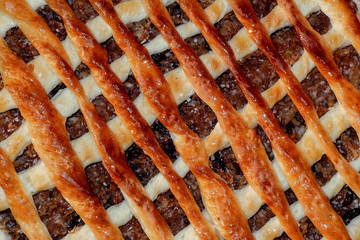 homemade apple pie with a lattice pastry crust covered with cinnamon and granulated sugar