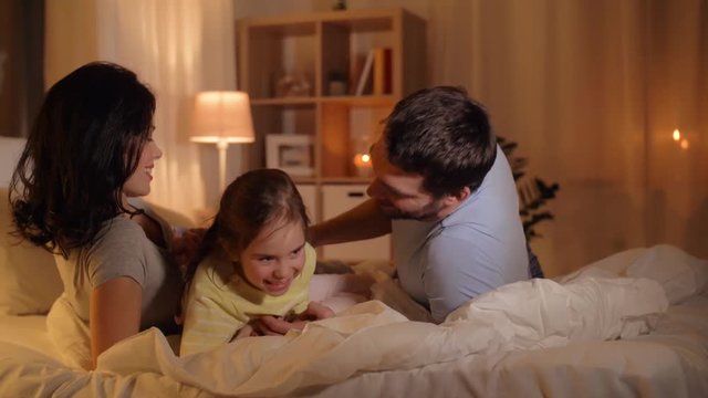 happy family having fun in bed at home
