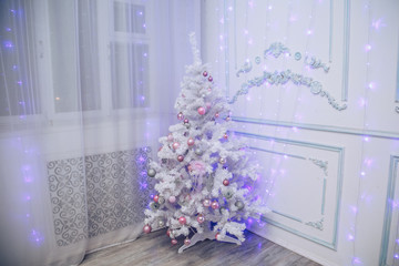 White Christmas tree in the decorations in the modern interior