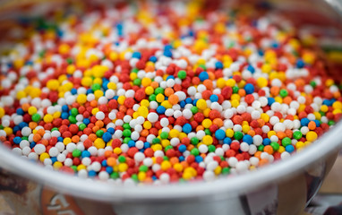 Small sweet sugar balls. Food colorful sugar balls in glass bowl