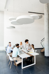 Business people around table during staff meeting