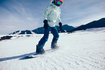 one snowboarder snowboarding in winter mountains