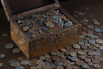 Wooden casket and a bunch of various coins
