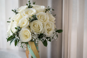 White rose flower bouquet in bundle shape for bridal in wedding ceremony