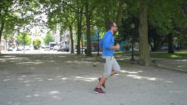 Young man jogging in city park
