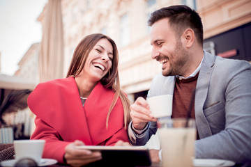Portrait of happy couple dating at coffee shop.
