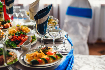 glasses and plates with food on the table in the restaurant for a festive dinner