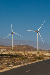 electric wind turbines farm, blue sky background