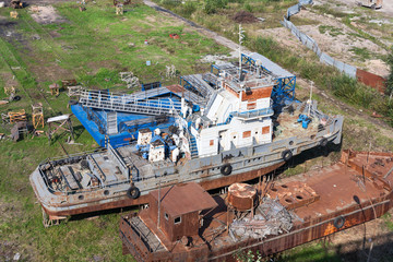 Obsolete and rusty vessel is in ship breaking yard ready for dismantling