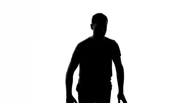 Man bouncing ball and passing it to another player, basketball training, shadow