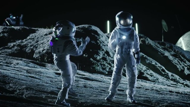 Male and Female Astronauts Wearing Space Suits Dance on the Surface of the Alien Planet. Humanity Colonizing Space Celebration Theme. 