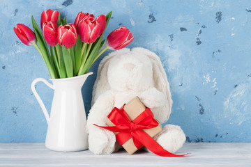 Red tulip flowers and easter rabbit toy