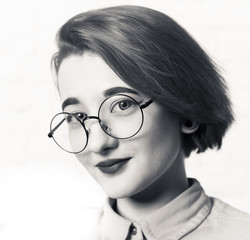 Shooting in the Studio. Portrait of a young girl with big glasses.
