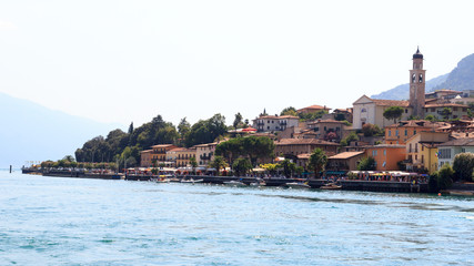 Townscape panorama of lakeside village Limone sul garda with boats and church at Lake Garda, Italy