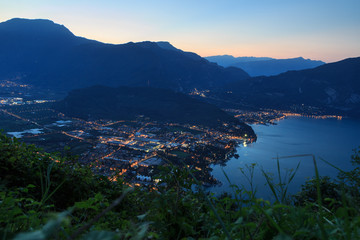 Riva del Garda town panorama at Lake Garda and mountains at night before sunrise, Italy