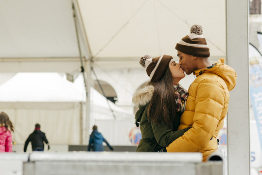 Cheerful couple embraced on rink