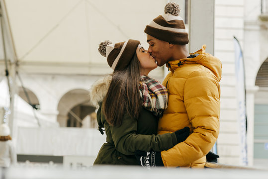 Cheerful couple embraced on rink