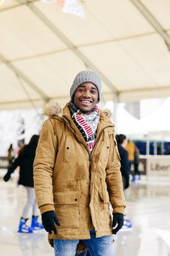 Cheerful ethnic man on rink