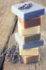 Assorted natural soap bars on wood