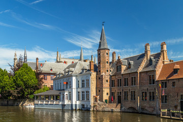 Typical medieval Flemish architecture of Bruges, Belgium. Red brick houses standing on the banks of...