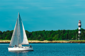 White sailboat traveling at Riga