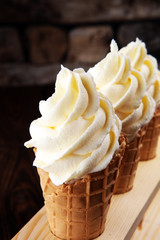 Vanilla frozen yogurt or soft ice cream in waffle cone.