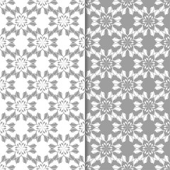 Fototapeta premium White and gray set of floral backgrounds. Seamless patterns