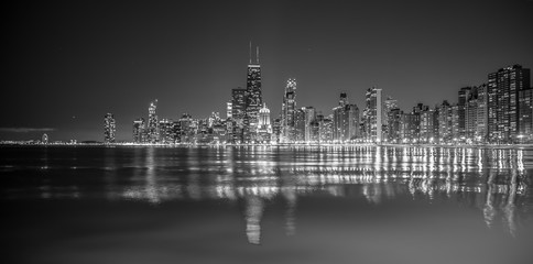 Big city skyline on water at night