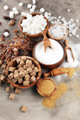 Various types of sugar, brown sugar and white on table