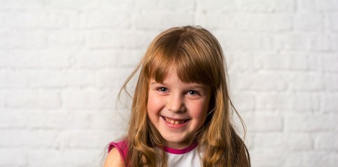 Portrait of a girl 6 years old. The girl is happy.
