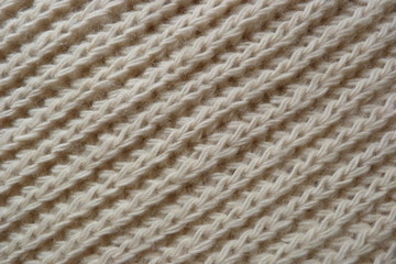 knitted scarf close-up beige knitted fabric yarn wool acrylic cotton natural thread close-knit vintage background for decoration hand-made background made by hand