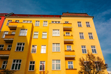 yellow colored apartment house with darken sky
