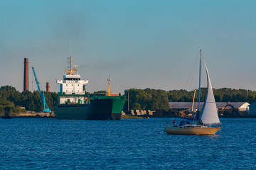 Green cargo ship in port