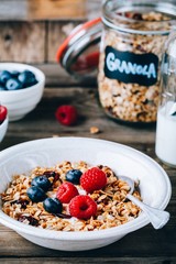Healthy breakfast bowl. Homemade granola with natural yoghurt, blueberries and raspberries
