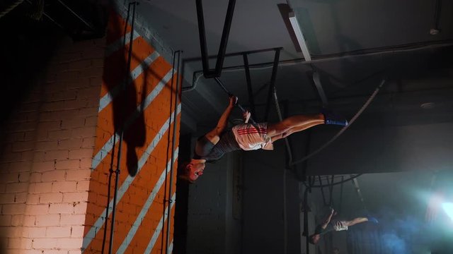 sportsman doing an exercise on a horizontal bar in the gym