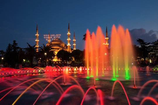 Blue Mosque with the fountain in the foreground, famous tourist destination in Istanbul, Turkey, on the first day of Ramadan with illuminated message meaning "Welcome the sultan of eleven months".