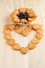 Cookies hearts in a saucer and on a table, laid out in the form of heart