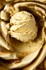 Caramel ice cream scoop background. Summer food concept, copy space, top view. Scooped texture. Scooping out creamy coffee ice-cream.