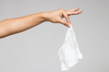 A hand pinches tissue isolate on white background.