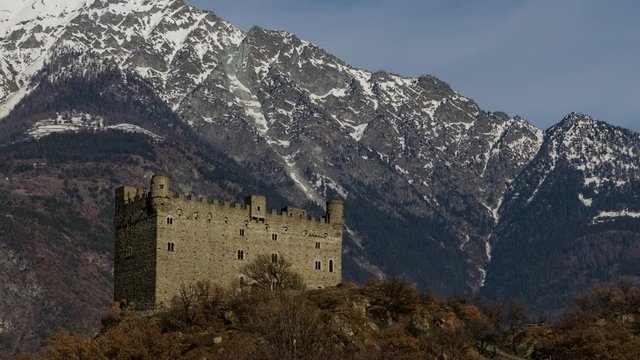 Ussel fraction of Chatillon, Valle d'Aosta, Italy 11 February 2018. Three-quarters rise to the left of the medieval castle of Ussel. Timelaps of 20 minutes in 10 seconds. The clouds flow over mountain