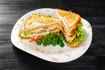Sandwiches with chicken and Bacon on a black wooden background