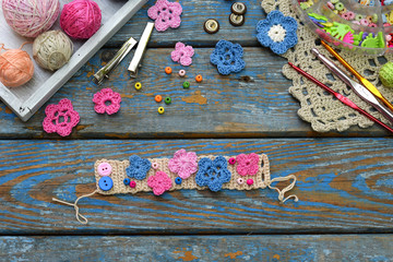 Needlework accessories for creating crocheted jewelry. Step 2 - sew crocheted flowers to bracelet or chain. DIY project. Small business. Income from hobby