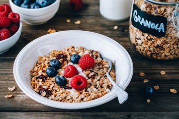 Healthy breakfast bowl. Homemade granola with natural yoghurt, blueberries and raspberries
