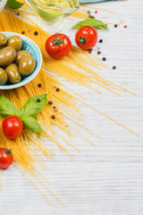 Ingredients for preparation pasta spaghetti - tomato, olive oil, spices, herbs, green olives, tomato sauce