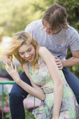 Fototapeta premium Cute young caucasian in couple enjoying their fresh romance, hugging and kissing