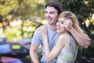 Obraz premium Cute young caucasian in couple enjoying their fresh romance, hugging and kissing