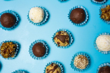 Homemade cookies in paper cups on blue background